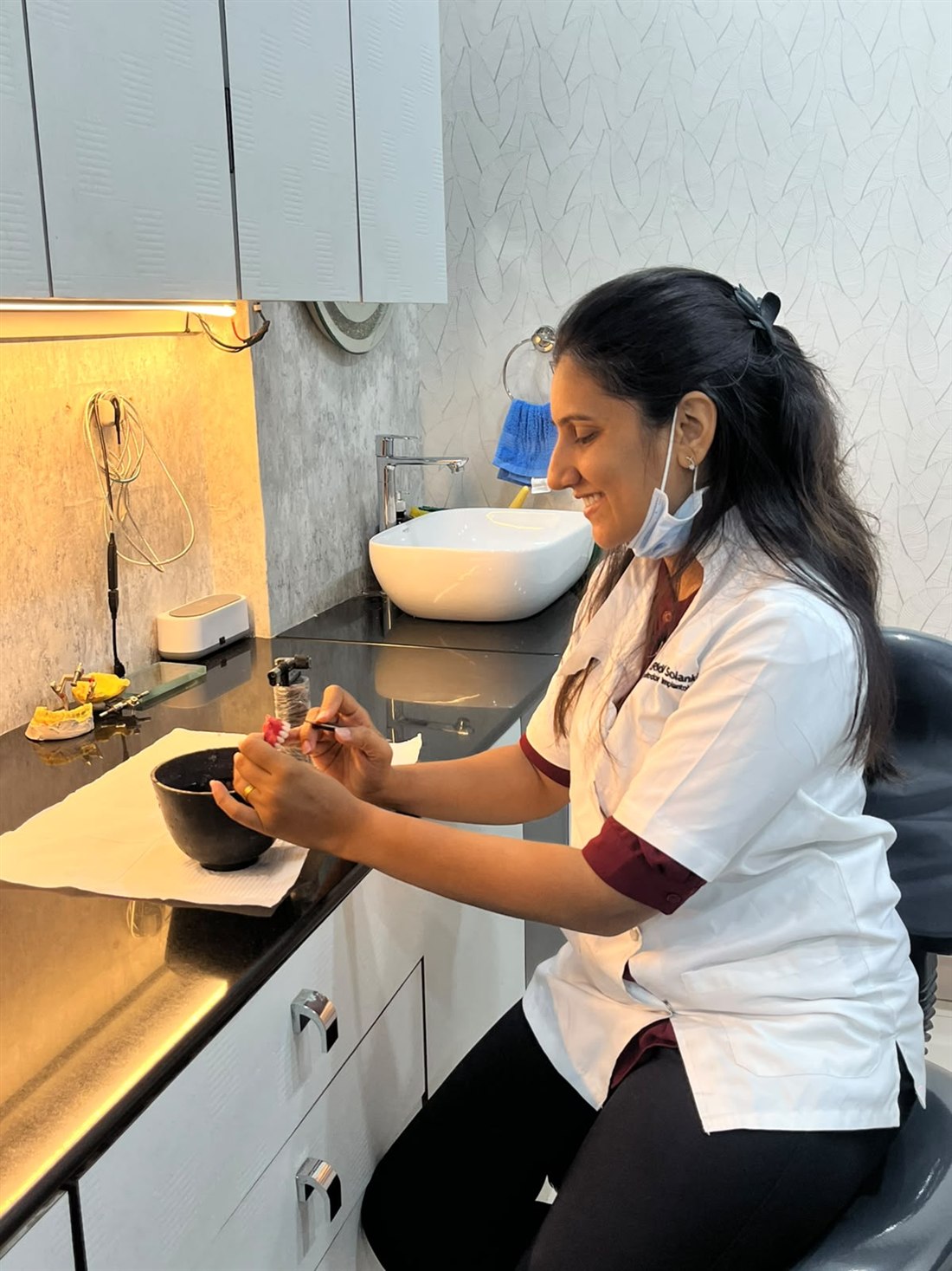 Dr. Riddhi Solanki shaping a prosthesis at the clinic bench
