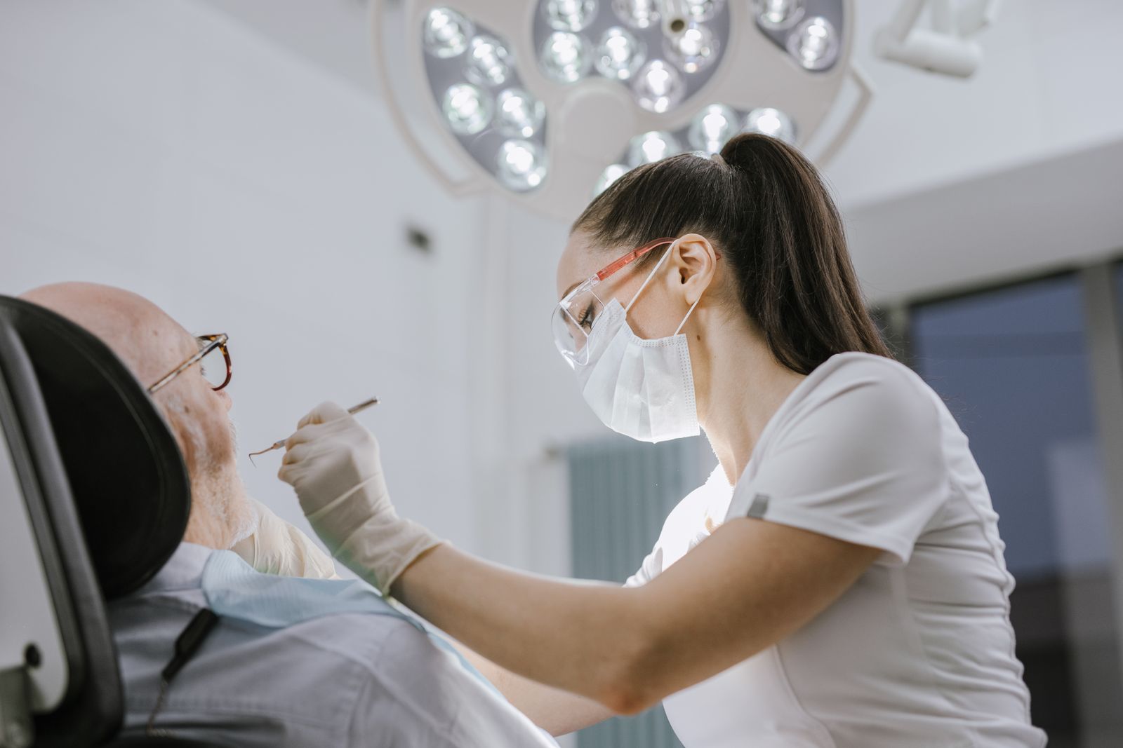 An endodontist carefully performing a root canal on a patient